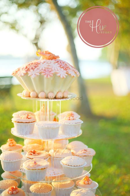 Orange and white theme cupcakes on stand as wedding cake