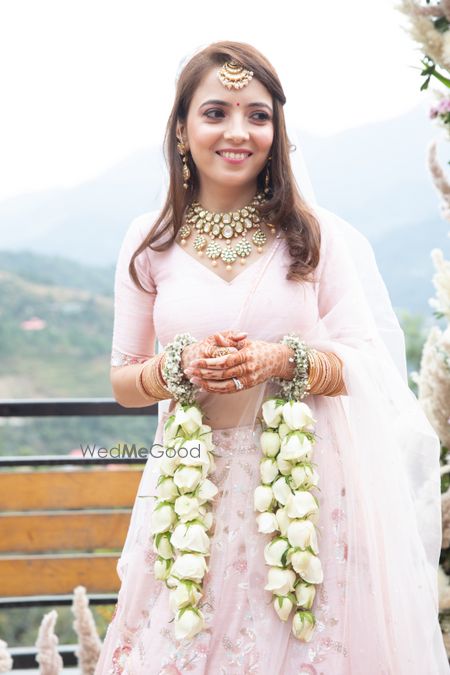 A happy bride wearing white floral keleere.