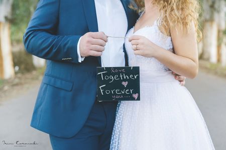Photo of Post wedding shoot with cute chalkboard prop
