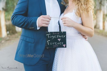 Photo of Post wedding shoot with cute chalkboard prop