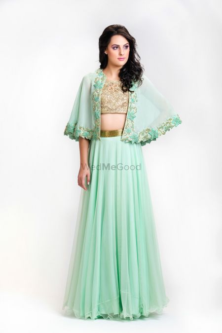Photo of mint and gold cape top with lehenga skirt