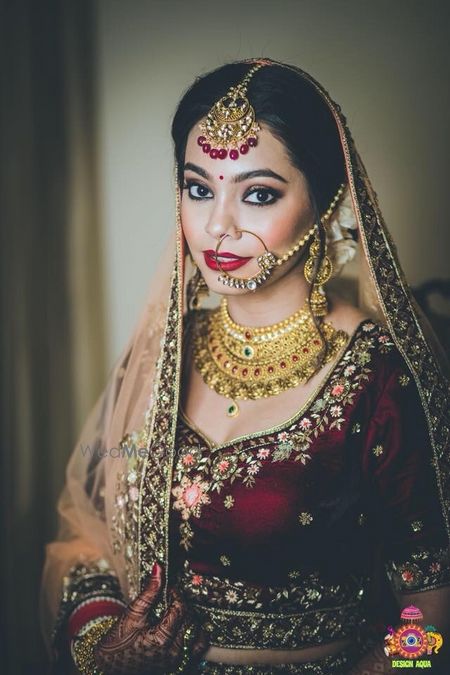 Photo of Winter bride in wine lehenga