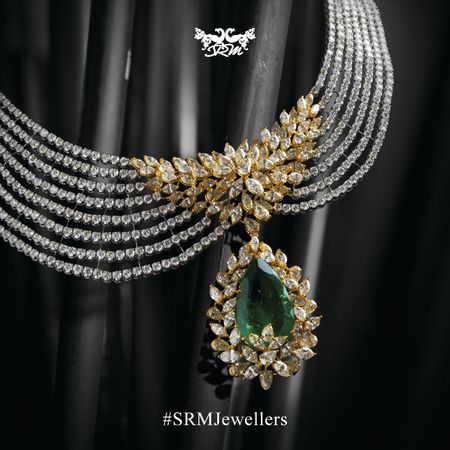 Photo of five string diamond necklace with emerald pear shaped drop and marquis stones