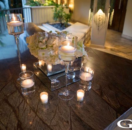 Photo of Candle lit table centerpiece with flowers