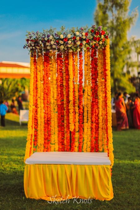 Photo of Floral seating for bride on mehendi