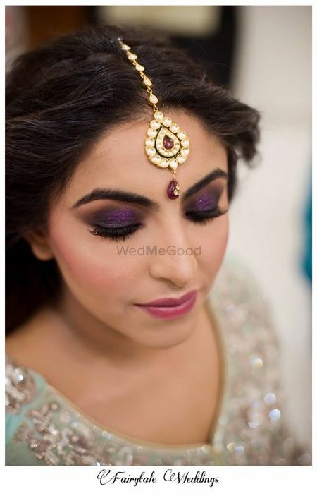 Photo of Purple Glitter Eye Makeup with Gold Maangtikka