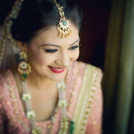 Pastel Pink Bride wearing Emerlad and Gold Jewelry
