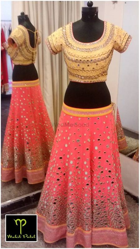 Photo of coral lehenga with mirror work and gold gota work blouse