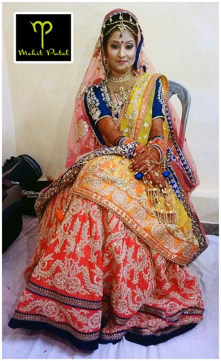 Photo of ombre red and orange bridal colorblocked lehenga