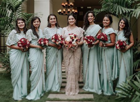 Photo of bride with bridesmaids in matching sarees