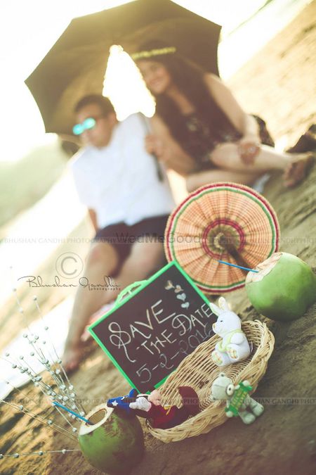 Photo of Beach theme save the date invite with props