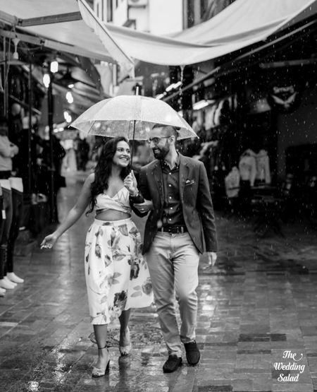 Photo of cool black and white couple pre wedding shot in the rain