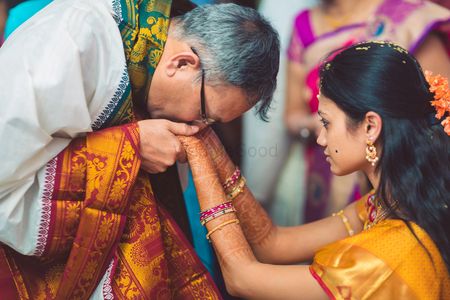 Bride with her father kissing her hands