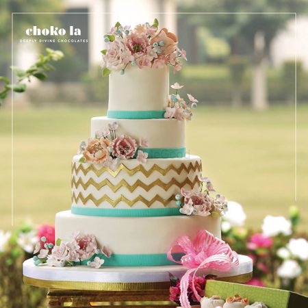 Photo of White Wedding Cake with Aqua and Gold Icing