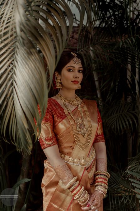 South indian bride in red and beige kanjivaram 