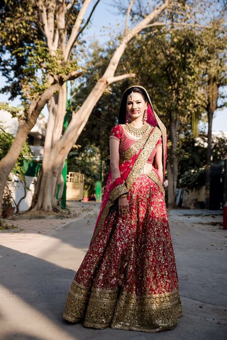 Bride Wearing Red and Gold Lehenga
