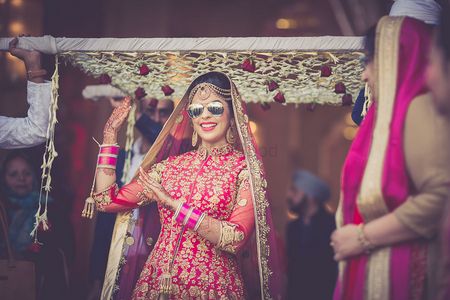 Photo of Cool bride dancing and entering wearing sunglasses
