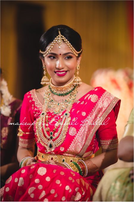 Fusion bride in red saree and layered necklaces 