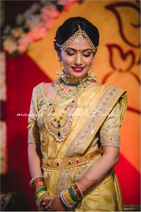 South Indian bride in yellow and gold saree 