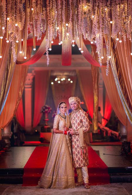 Photo of Red and gold theme couple wedding portrait