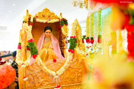 Photo of Bride entry in gold palki
