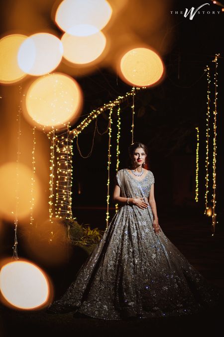 Bride dressed in a glimmering silver lehenga.