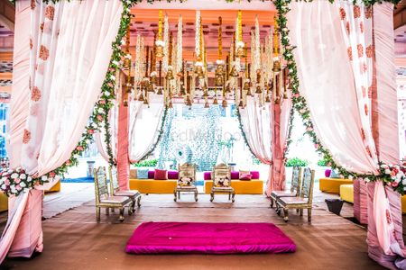 Photo of Mandap in pink with floral printed drapes