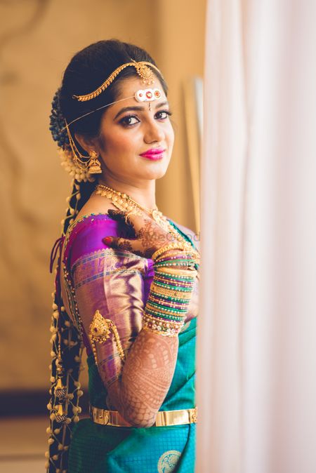 A south Indian bride wearing a contrasting blouse with embellished sleeves 