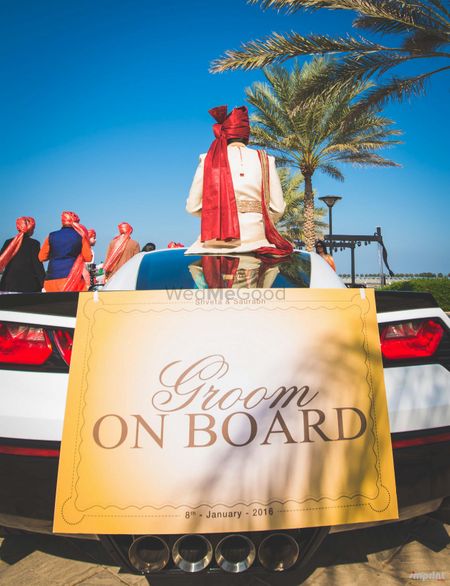 Photo of Fun groom entry idea with sign on car
