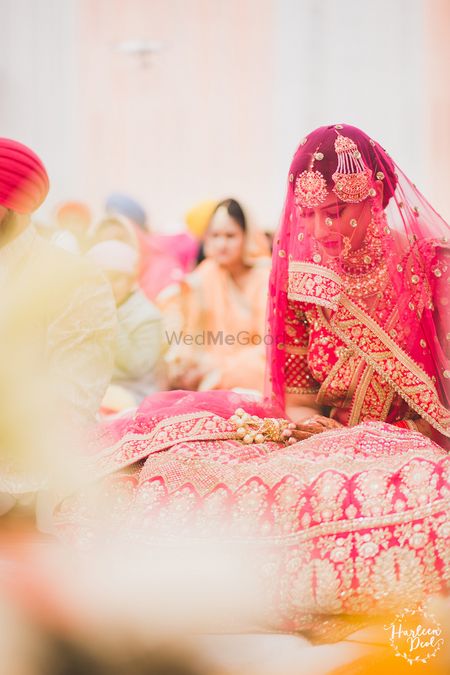 Photo of Sikh bride with veil in red lehenga