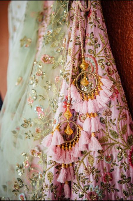 Photo of Pretty pink andgold bridal latkans for an Indian wedding