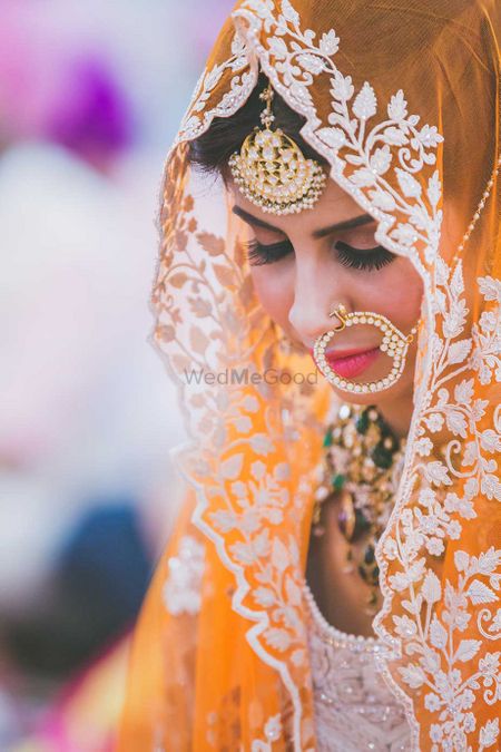 Photo of Bride in Orange Lehenga and White Embroidery and Nath