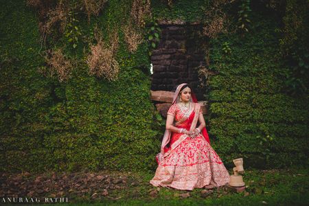 Bridal portrait in pink against botanical wall