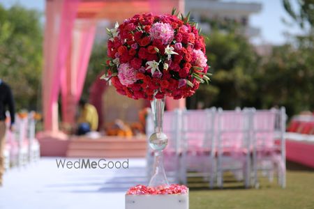 Photo of Pretty floral centerpiece with pink and red flowers