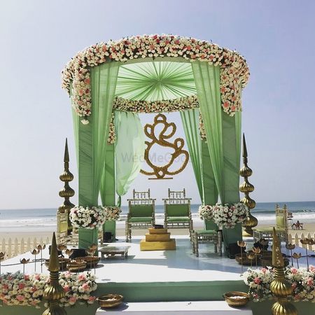 A floral mandap decor with green curtains