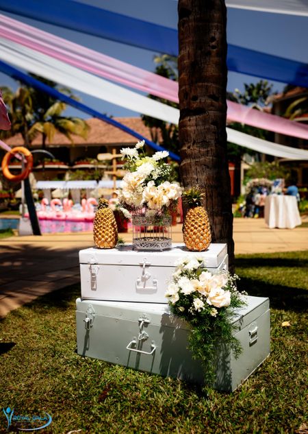 Hand-painted trunks with pineapple and flowers for a photobooth.