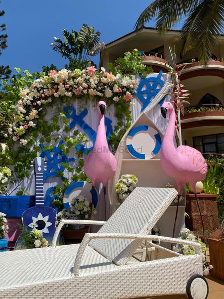 Nautical themed decor with flamingos and floral arrangements