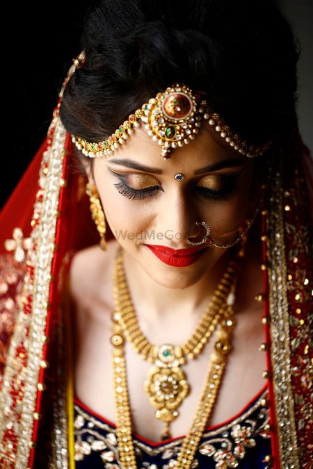 Bridal makeup with Smokey gold eyes and deep red lips