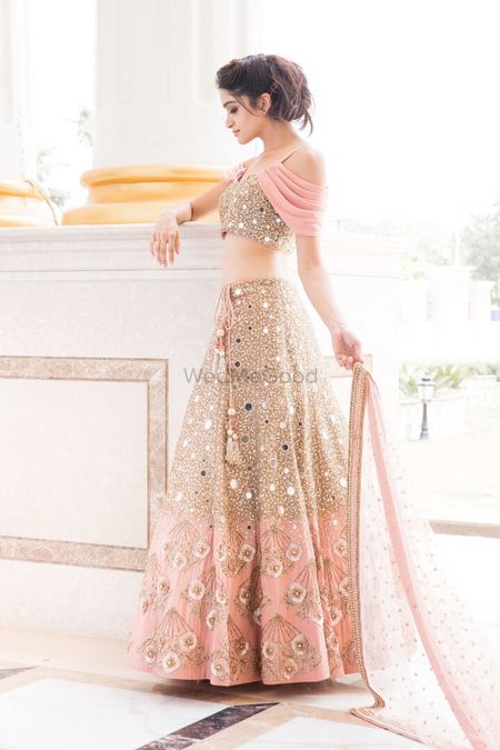 Photo of Pretty peach lehenga with mirror work and falling sleeves blouse