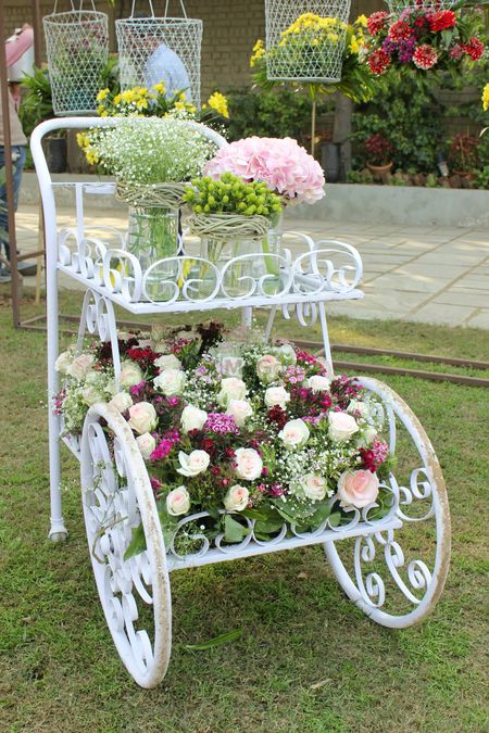 Photo of White Iron Cart with Floral Arrangement