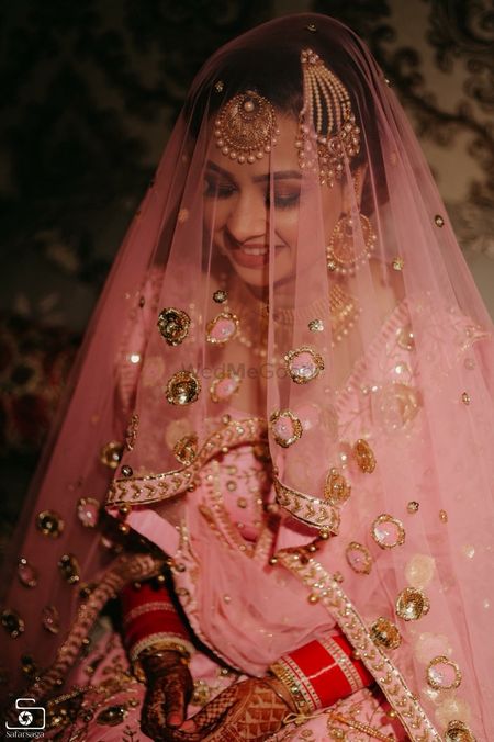 Beautiful bridal portrait with pink and gold lehenga for wedding 
