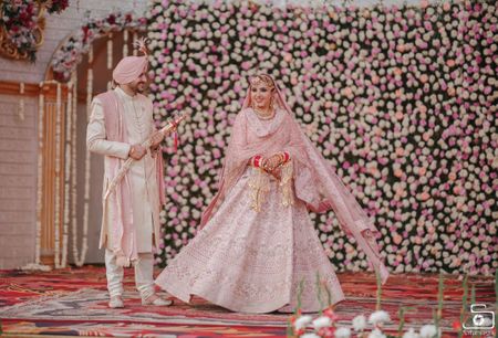 Sikh couple color-coordinating in pink & white.