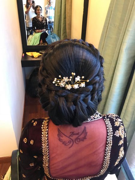 Stunning braided bridal bun with pearl hair accessories