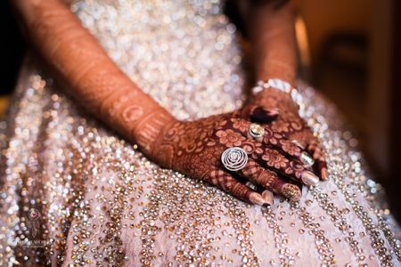 Bridal hands with mehendi and cocktail ring