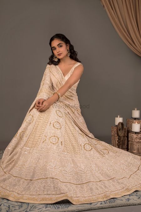 Ivory and gold chikankari lehenga.