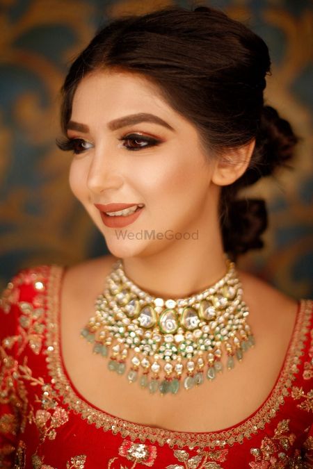 A bride in red with subtle makeup