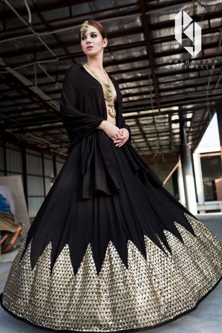 Black and gold gown for sangeet with revealing neckline
