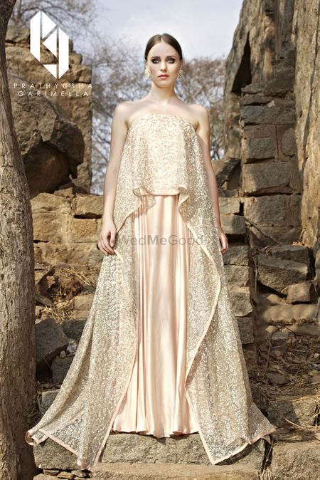 Photo of Peach and gold off shoulder cape lehenga