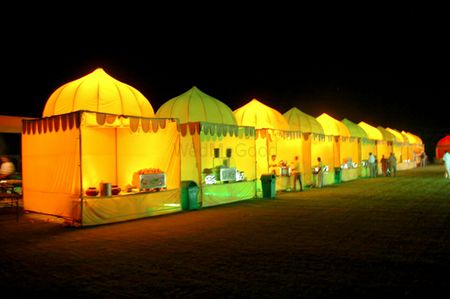 Photo of yellow and green food stalls