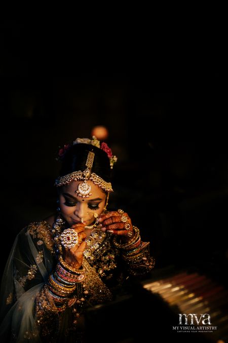 Photo of Bride with heavy jewellery adjusting nosering